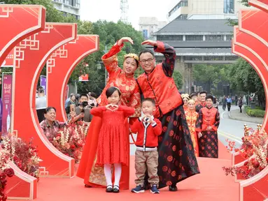 Sepasang mempelai berpose dengan para pengiring pengantin dalam pernikahan massal bergaya China di Changsha, Provinsi Hunan, China, 25 September 2020. Sebanyak 71 pasangan resmi menjadi suami-istri usai mengikuti upacara pernikahan tradisional dalam acara nikah massal. (Xinhua/Chen Zhenhai)