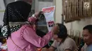 Warga melihat kertas suara sebelum pemungutan suara ulang (PSU) Pemilu 2019 di TPS 18 Malakasari, Duren Sawit, Jakarta Timur, Sabtu (27/4). Sebanyak 11 TPS di tiga wilayah di DKI Jakarta melaksanakan pemungutan suara ulang yang digelar serentak hari ini. (merdeka.com/Imam Buhori)
