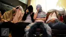 Beberapa perempuan warga negara asing illegal yang terjaring operasi pengawasan menutupi wajah saat rilis di Ditjen Imigrasi, Jakarta, Jumat (13/1). Diduga, para WNA tersebut bekerja sebagai pekerja seks komersial (PSK). (Liputan6.com/Helmi Fithriansyah)