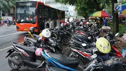 Sejumlah motor parkir di sekitar TPU Karet Bivak, Jakarta, Sabtu (4/5). Ramainya warga yang berziarah jelang Ramadan menimbulkan kemacetan di kawasan tersebut akibat banyak parkir liar serta warga yang berlalu lalang. (Liputan6.com/Immanuel Antonius)