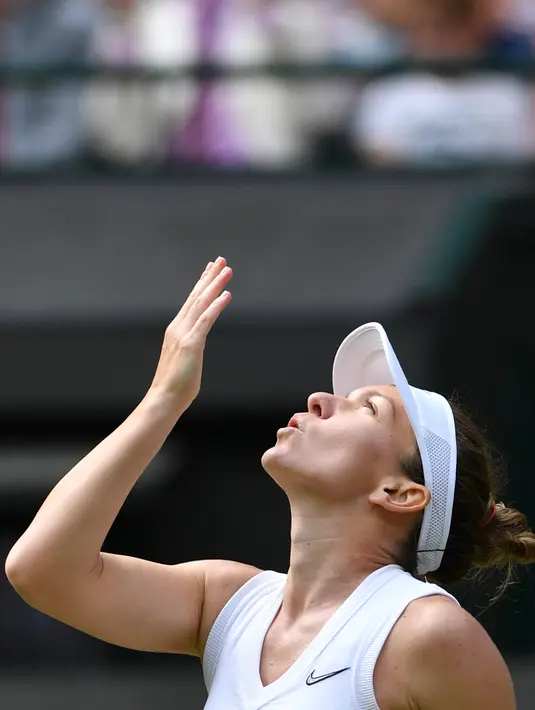 Petenis Rumania, Simona Halep merayakan kemenangan atas petenis AS, Cori Gauff pada babak keempat Wimbledon 2019 di All England Lawn Tennis Club, Senin (8/7/2019). Halep yang merupakan mantan petenis nomor satu dunia menghentikan langkah petenis 15 tahun itu dengan skor 6-3, 6-3. (GLYN KIRK/AFP)