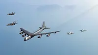 Sebuah pesawat Stratofortress B-52H Angkatan Udara Amerika Serikat (tengah) terbang dalam formasi dengan pesawat tempur KF-16 dan F-15K Angkatan Udara Korea Selatan di atas laut barat Semenanjung Korea saat latihan udara bersama di Korea Selatan, Senin (6/3/2023). Amerika Serikat dan Korea Selatan mengatakan latihan itu diperlukan untuk membela diri dan melawan ancaman yang meningkat dari program rudal balistik dan senjata nuklir Korea Utara. (South Korea Defense Ministry via AP)