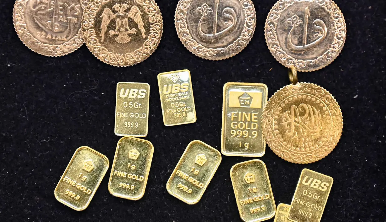 Sebelumnya, harga emas Antam dipatok Rp 2.652.000 per gram. Tampak dalam foto, koin dan batangan emas dipajang di sebuah toko perhiasan di Banda Aceh pada Rabu 14 Januari 2026. (CHAIDEER MAHYUDDIN/AFP)