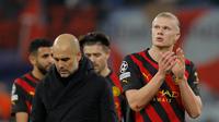 Pelatih Manchester City, Pep Guardiola tertunduk usai bertanding melawan  RB Leipzig pada pertandingan leg pertama babak 16 besar Liga Champions di Red Bull Arena, Jerman, Kamis (23/2/2023). Usai pertandingan, Guardiola mengumpulkan para pemainnya di lapangan mencoba menyemangati timnya yang kecewa. (AFP/Odd Andersen)