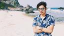 Saat pergi berlibur di pantai, kacamata menjadi fashion item yang tak boleh terlewatkan bagi bintang sinetron ini. Berbusana baju pantai dengan kacamata hitam, membuat penampilan Riza terlihat lebih maskulin. (Liputan6.com/IG/@rizasyah_14)