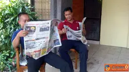 Citizen6, Bali: Pada Minggu, 10 April 2011 di Jalan PB Sudirman, Kampus Udayana. Yudiartwan (24) dan Komang Jaunuadi (37) mengisi waktu di sela-sela waktu kerja dengan membaca koran, agar tidak bosan dan juga menambah informasi. (Pengirim: Kelompok 11) 