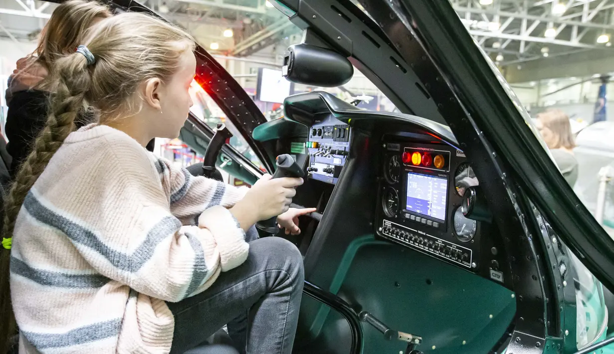 Seorang anak perempuan terlihat duduk di dalam sebuah helikopter di pameran industri helikopter internasional HeliRussia 2020 di Moskow, Rusia (16/9/2020). Pameran tersebut berlangsung di Moskow dari 15 hingga 17 September. (Xinhua/Alexander Zemlianichenko Jr)
