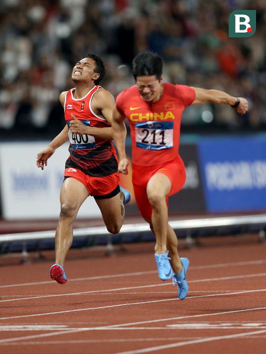 Pelari Indonesia, Lalu Muhammad Zohri, saat berlaga pada nomor 100 meter Asian Games di SUGBK, Jakarta, Minggu (26/8/2018). Lalu Zohri finish diurutan ke tujuh dengan catatan waktu 10,20 detik. (Bola.com/Peksi Cahyo)