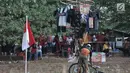 Petugas dari UPK Badan Air Dinas Lingkungan Hidup (DLH) Kecamatan Duren Sawit  mencapai puncak saat lomba panjat pinang dalam rangka HUT ke-74 RI di Kanal Banjir Timur, Jakarta, Sabtu (17/8/2019). (merdeka.com/Iqbal S. Nugroho)