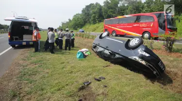 Mobil Innova terbalik di jalur rumput di KM 208 Tol Palikanci (Palimanan-Kanci), Jawa Barat, Rabu (21/6). Pengemudi mobil bernopol B 2247 TKL itu diduga mengantuk dan membanting setir hingga mengakibatkan mobil terbalik. (Liputan6.com/Gempur M Surya)