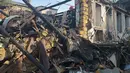 Serangan ini memicu kebakaran besar, dan merusak sejumlah infrastruktur sipil lainnya. Tampak dalam foto, para petugas penyelamat membersihkan puing-puing bangunan tempat tinggal yang hancur akibat serangan Rusia di Odesa, Ukraina, Jumat 24 April 2026. (AP Photo/Michael Shtekel)