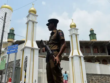 Seorang polisi bersenjata meningkatkan pengamanan sebuah masjid menjelang Salat Jumat di ibukota Sri Lanka, Kolombo, Jumat (9/3). Penjagaan dilakukan menyusul kekerasan anti-Muslim yang dikhawatirkan menyebar ke seluruh negeri. (ISHARA S.  KODIKARA/AFP)