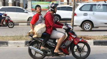 Pembeli membawa kambing yang dibeli di kawasan Kemayoran, Jakarta, Kamis (31/8). H-1 jelang Idul Adha, hewan kurban mulai didistribusikan para pedagang kepada sejumlah pembeli di Ibukota. (Liputan6.com/Immanuel Antonius)
