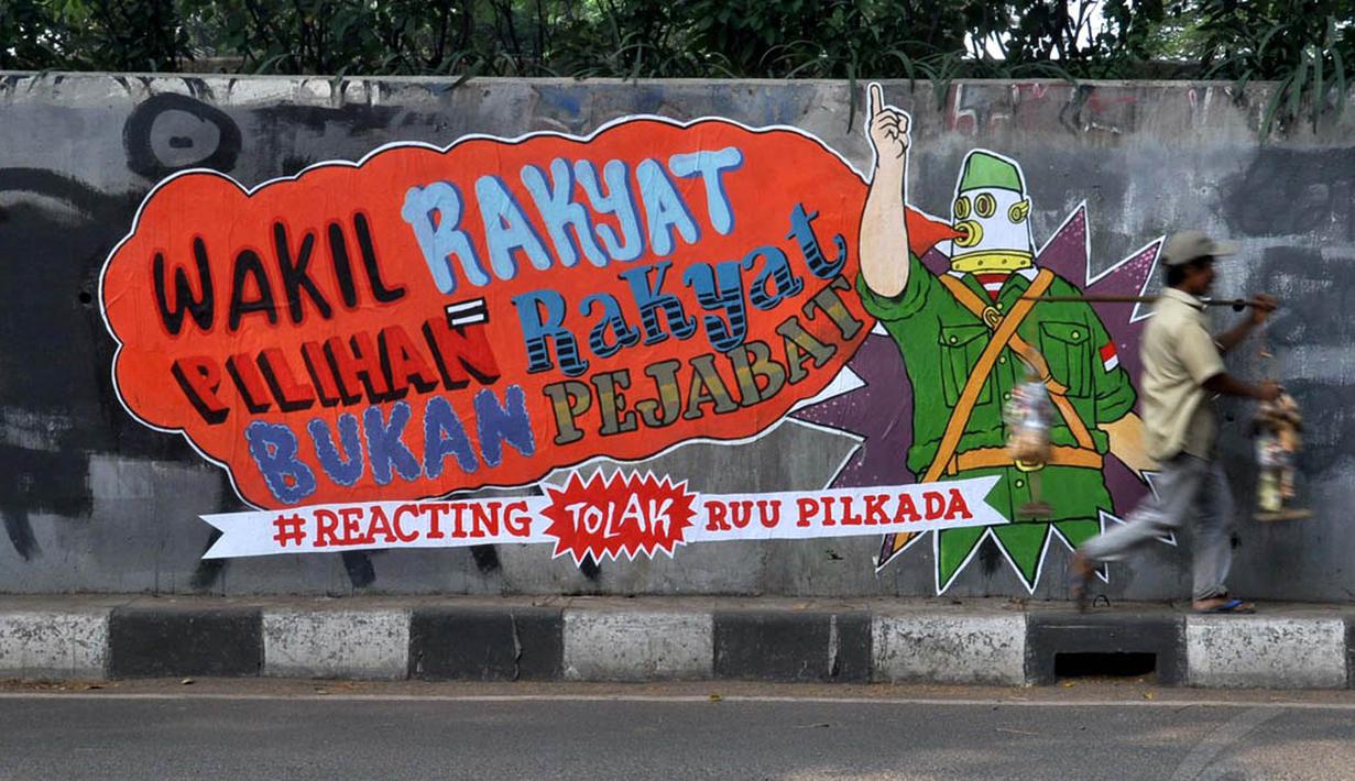 Sebuah mural terpampang di tembok fly over kawasan Pejompongan, Jakarta, (28/9/14). (Liputan6.com/Miftahul Hayat) 