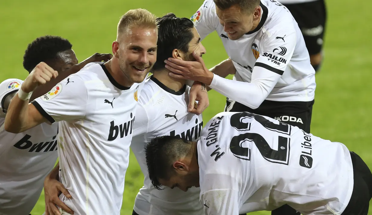Para pemain tim Valencia melakukan selebrasi setelah mencetak gol ketiga tim mereka ke gawang Real Madrid pada lanjutan La Liga di Stadion Mestalla, Selasa (9/11/2020) dinihari WIB. Real Madrid kalah telak 1-4 dari tuan rumah Valencia. (AP Photo/Alberto Saiz)