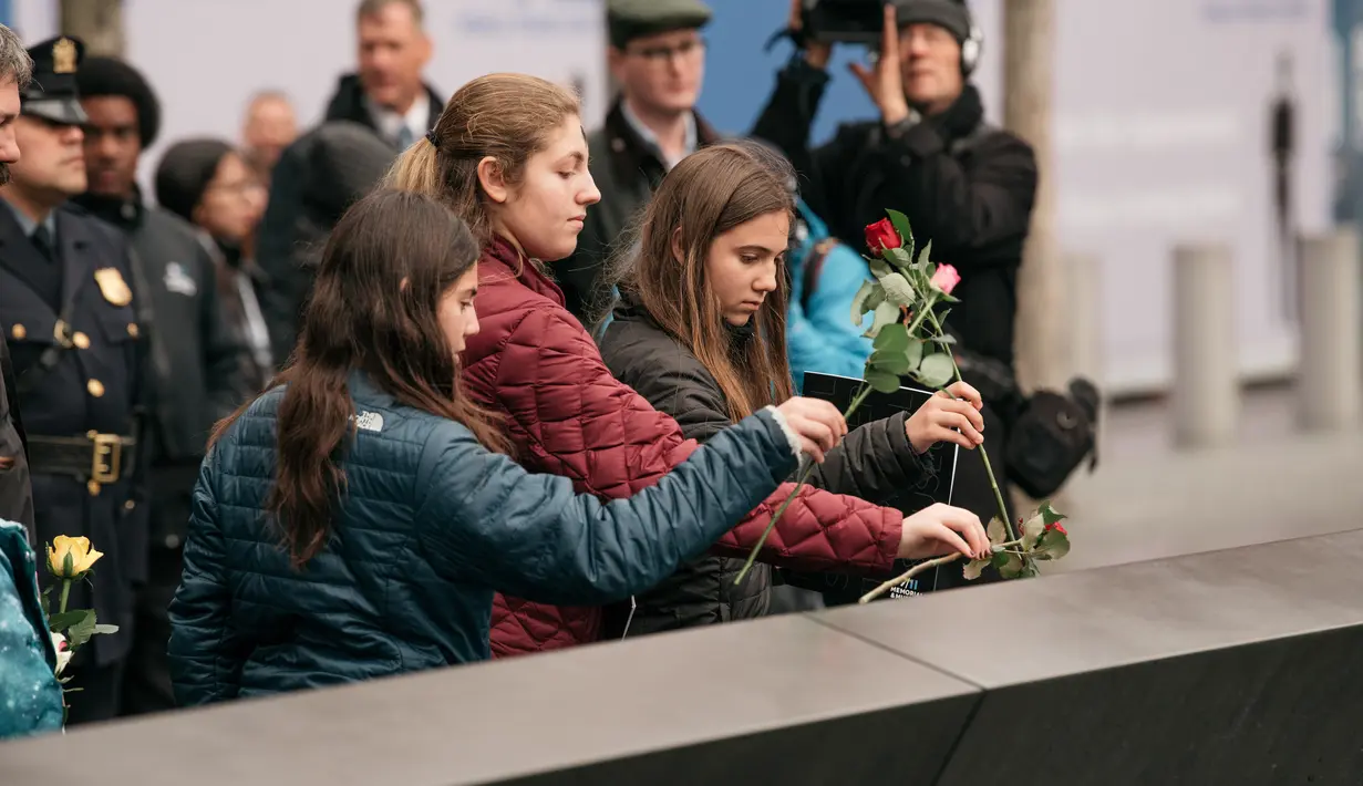 Kerabat meletakkan mawar di atas plakat bertuliskan nama-nama korban pengeboman World Trade Center 1993 pada upacara peringatan “Tragedi 9/11” di New York, Rabu (26/2/2020). 27 tahun lalu teroris meledakkan bom di sebuah garasi parkir WTC yang menewaskan enam korban. (Scott Heins/Getty Images/AFP)