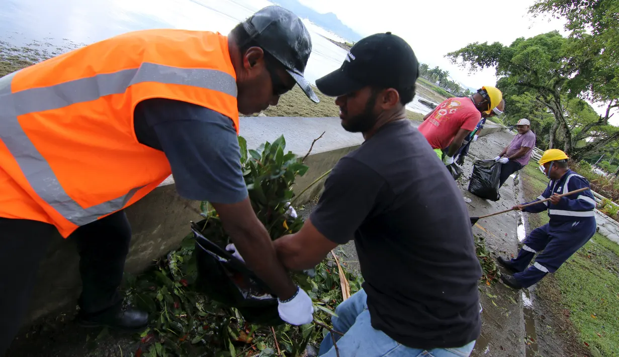 Petugas dinas kebersihkan membersihkan puing-puing akibat terjangan badai paling kuat yang menghantam Ibu kota Fiji, Suva, Senin (22/2). Badai Winston memporak-prandakan negara kepulauan Fiji hingga menewaskan sedikinya 10 orang. (REUTERS/Steven Saphore)