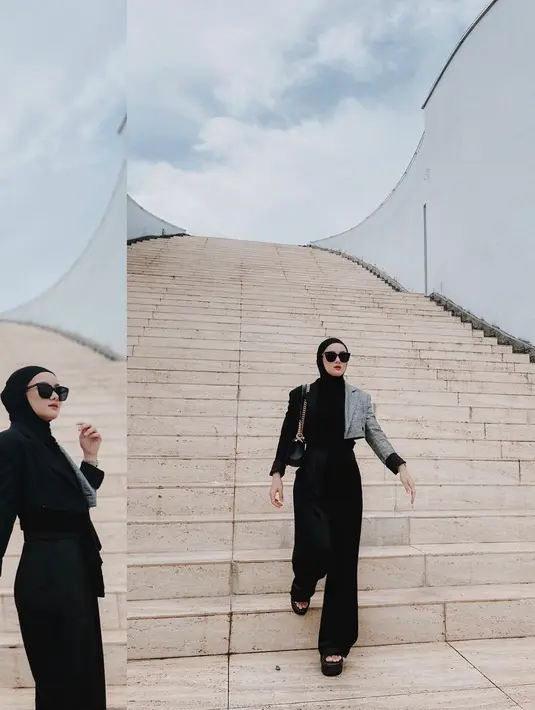 Saat berada di Makassar, Dinda Hauw memamerkan OOTD-nya yang serba hitam. Mengenakan dual tone blazer yang dipadukan dengan trouser, Dinda Hauw tampil stylish dengan kacamata, hijan, dan tas rantai hitam. (instagram/dindahw)