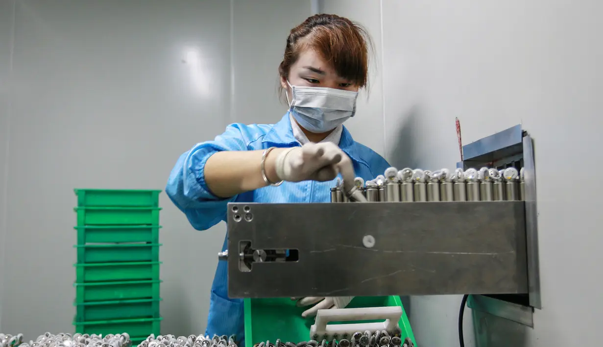 Karyawan wanita saat bekerja di sebuah pabrik baterai di Huaibei di provinsi Anhui timur China (6/3). Huaibei adalah rumah bagi banyak perusahaan kimia, konstruksi, mesin, tekstil, listrik, elektronik, dan perusahaan industri mineral. (AFP Photo/STR)