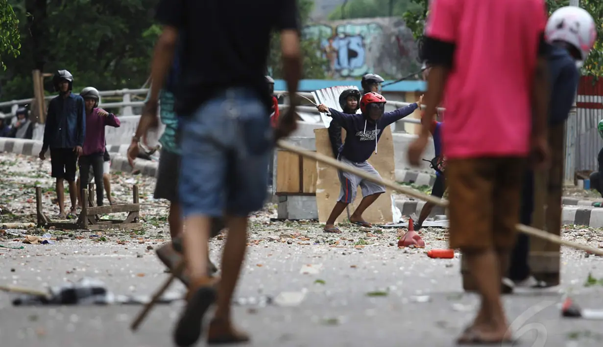 Puluhan warga Jalan Tambak, Jakarta Pusat dan warga Gang Tuyul, Manggarai, Jakarta Selatan, terlibat tawuran pada Minggu (30/11/2014). Tawuran ini berimbas pada penutupan arus lalu lintas dari Manggarai menuju Tebet. (Liputan6.com/Faizal Fanani)