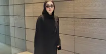 Sivia mengenakan pashimina hitam panjang polos serasi dengan abaya hitam polosnya. Dipadukan kacamata hitam sambi membawa tas hitamnya. Mengenakan sepatu sneakers hijau. [@siviazizah]