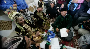 Sepasang calon pengantin mempersiapkan diri sebelum proses ijab qabul di atas gerbong kereta Prameks jurusan Jogja-Solo selama acara nikah massal bertema “Stasiun Cinta dan Masa Depan”di Stasiun Tugu Yogyakarta, Selasa (6/9). (Liputan6.com/Boy Harjanto)