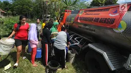 Warga antre mengambil air bersih bantuan Badan Penanggulangan Bencana Daerah (BPPD) Kabupaten Bogor di Pabuaran, Ciampea, Bogor, Jawa Barat, Senin (6/8). BPPD Kabupaten Bogor mengerahkan lima truk tangki air bersih setiap hari. (Merdeka.com/Arie Basuki)