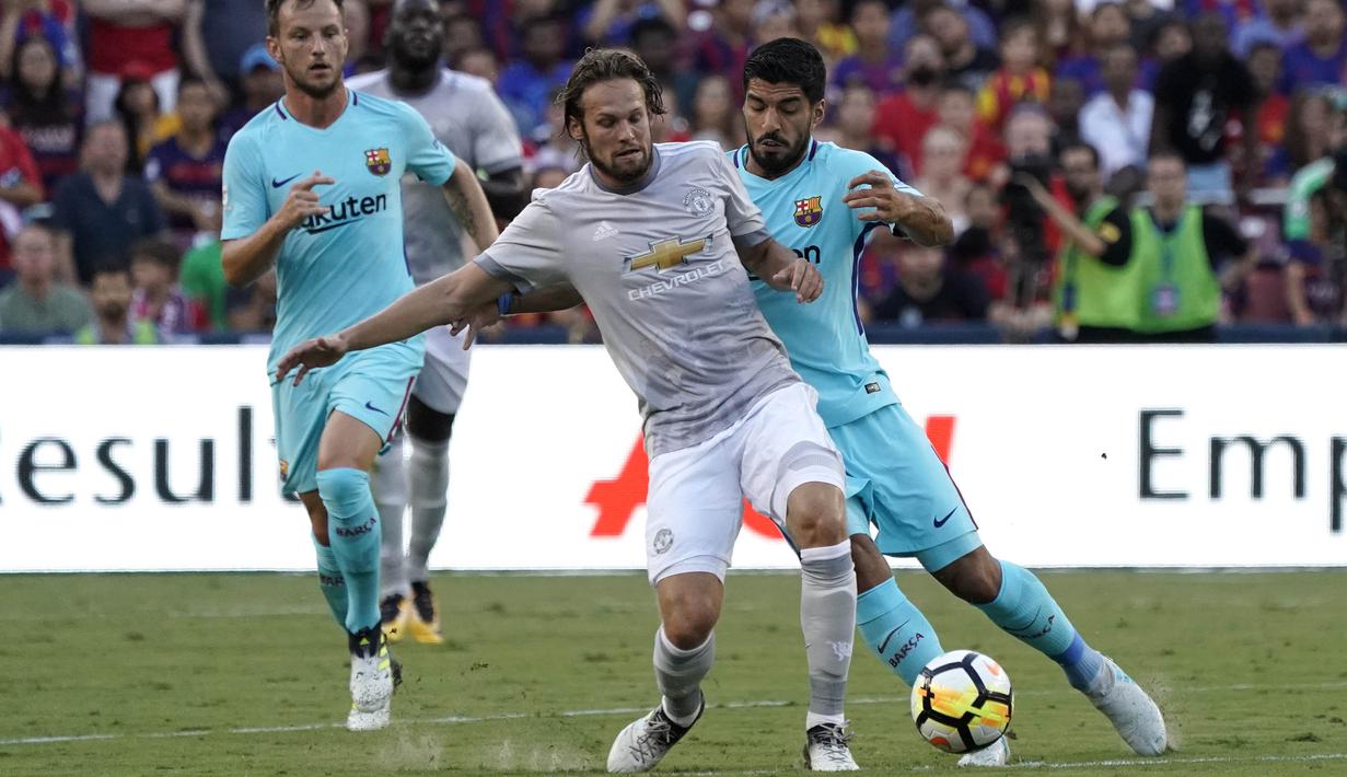 Striker Barcelona, Luis Suarez, berebut bola dengan bek Manchester United, Daley Blind, pada laga ICC di Stadion FedEx Field, Maryland, Rabu (26/7/2017). Barcelona menang 1-0 atas Manchester United. (EPA/Shawn Thew)