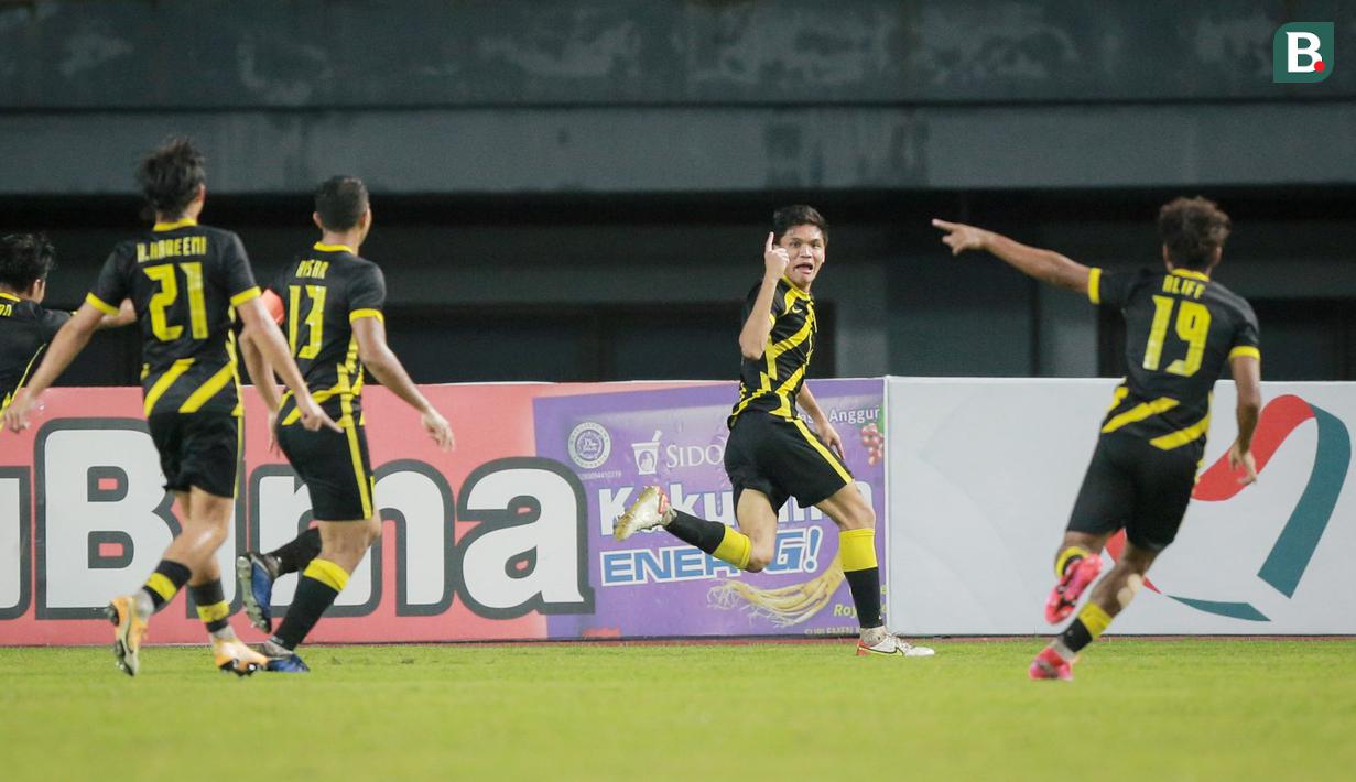 <p>Pemain Timnas Malaysia U-19, Muhammad Faiz, melakukan selebrasi usai mencetak gol ke gawang Timnas Laos U-19 pada laga final Piala AFF U-19 2022 di Stadion Patriot Chandrabhaga, Bekasi, Jumat (15/7/2022). (Bola.com/Bagaskara Lazuardi)</p>