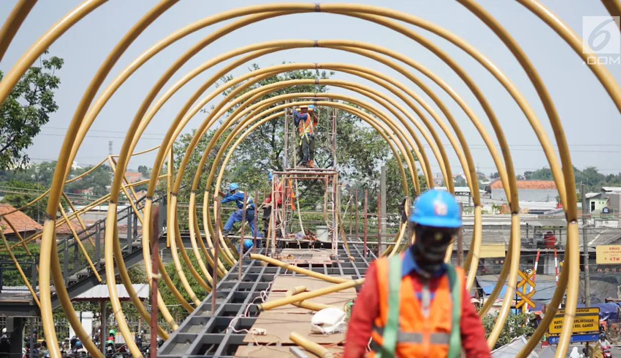 Pekerja menggarap proyek pembangunan Jembatan Penyebaran Orang (JPO) Pasar Minggu di Jakarta Selatan, Kamis (26/9/2019). JPO berdesain artistik senilai Rp 7 miliar tersebut ditargetkan rampung pengerjaannya pada Desember 2019 mendatang. (Liputan6.com/Immanuel Antonius)