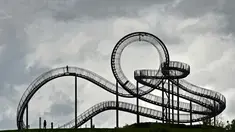 Orang-orang berjalan di sebuah instalasi tangga melingkar "Tiger and Turtle" di Duisburg, Jerman, 30 April 2018. Instalasi seni ini adalah patung jalan setapak menyerupai roller coaster yang berada di atas puncak bukit. (AP/Martin Meissner)