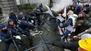 Polisi dan Demonstran terlibat bentrok saat aksi menolak Reformasi Pensiun di Brussels, Belgia, Selasa (15/11). Mereka menolak rencana pemerintah yang akan menaikkan usia pensiun dari 56 menjadi 63 tahun. (REUTERS / Yves Herman)