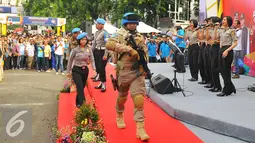 Anggota POLRI mengenakan seragam dan senjata lengkap berjalan diatas panggung saat parade busana di Bunderan HI, Jakarta (5/2). Kegiatan ini dalam rangka mensosialisasikan penerimaan anggota POLRI kepada masyarakat luas. (Liputan6.com/Angga Yuniar)