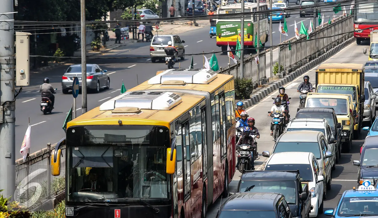 Bus Transjakarta melintas di Kawasan Mampang, Jakarta, Rabu (24/6/2015). Pemprov DKI Jakarta berencana meninggikan jalur bus Transjakarta dengan memasang movable concrete barrier (MCB) dan pintu otomatis. (Liputan6.com/Faizal Fanani)