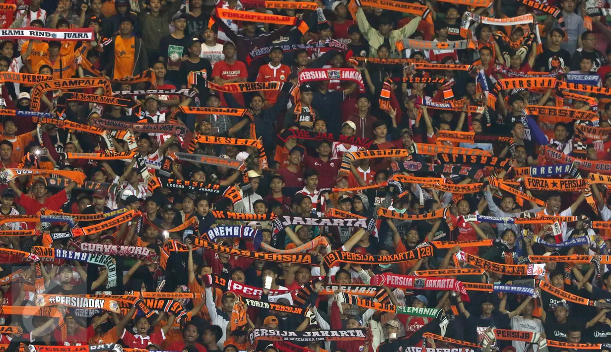 Suporter Persija membentangkan syal saat menyaksikan timnya berlaga melawan Madura United FC pada lanjutan Liga 1 di Stadion Patriot Candrabhaga, Bekasi, Kamis (4/5). Persija kalah 0-1. (Liputan6.com/Helmi Fithriansyah)