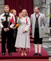 Putri Mahkota Norwegia Mette-Marit, Pangeran Mahkota Norwegia Haakon, dan Pangeran Norwegia Sverre Magnus menyapa pawai anak-anak selama perayaan hari nasional di Skaugum di Asker, dekat Oslo, Norwegia, pada 17 Mei 2026.  (dok. Lise Åserud / NTB / AFP)