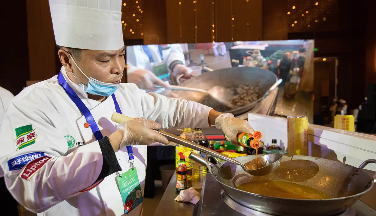 Seorang kontestan memasak dalam kompetisi keterampilan kuliner Sichuan yang diselenggarakan oleh Federasi Industri Katering China Sedunia di Meishan, Provinsi Sichuan, China barat daya (16/11/2020). (Xinhua/Jiang Hongjing)