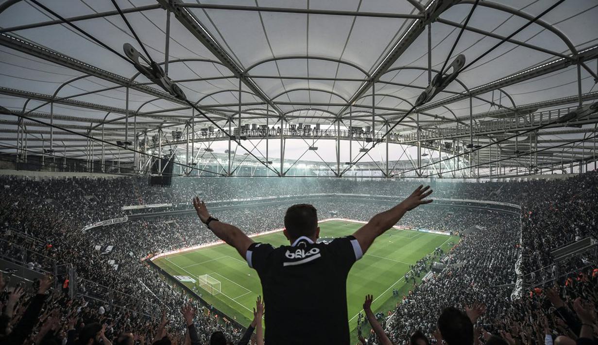 Aksi suporter Besiktas saat mendukung timnya bertanding melawan Bursaspor dalam laga Liga Super Turki di Stadion Vodafone Arena, Istanbul, Turki, (11/4/2016). (AFP/Ozan Kose)