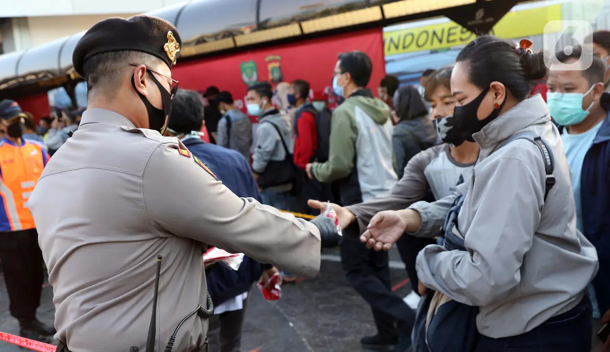 Personel polisi membagikan masker kepada calon penumpang kereta di area pedestrian Stasiun Terpadu Tanah Abang, Jakarta, Kamis (27/8/2020). Guna menekan penyebaran Covid-19, Polda Metro Jaya dan Kodam Jaya terus mengampanyekan pentingnya menaati protokol kesehatan. (Liputan6.com/Helmi Fithriansyah)