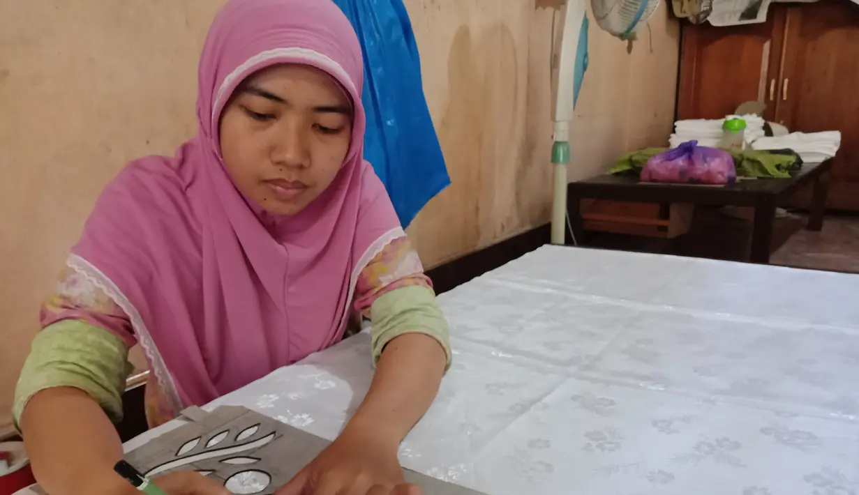 Pengrajin melukis motif sasirangan yang diinginkan di atas kain ukuran 2 meter menggunakan kain katun dan sutera di daerah Sasiranga, Banjarmasin, Kalimantan Selatan (16/1/2017). (Liputan6.com/Novi Nadya)