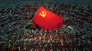 Penampil berpakaian seperti petugas penyelamat berkumpul di sekitar bendera Partai Komunis selama pertunjukan gala menjelang peringatan 100 tahun berdirinya Partai Komunis China di Beijing, China, 28 Juni 2021. Partai Komunis China akan merayakan HUT ke-100 pada 1 Juli 2021. (AP Photo/Ng Han Guan)