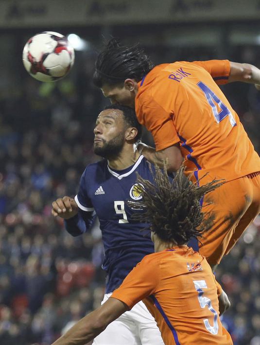 Duel pemain Skotlandia, Matt Phillips (kiri) dengan pemain Belanda, Karim Rekik pada laga persahabatan di Pittodrie, Aberdeen, Skotlandia (9/11/2017). Belanda menang 1-0. (Andrew Milligan/PA via AP)