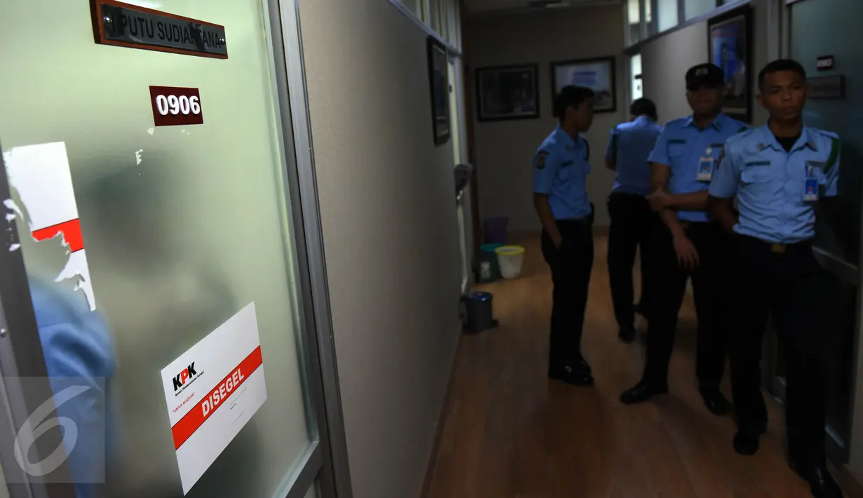 Petugas Pengamanan Dalam DPR menjaga pintu masuk ke ruang anggota Komisi III DPR, I Putu Sudiartana, di Kompleks Parlemen, Senayan, Jakarta, Kamis (30/6). Penyidik KPK tengah menggeledah ruang kerja Putu Sudiartana. (Liputan6.com/Johan Tallo)