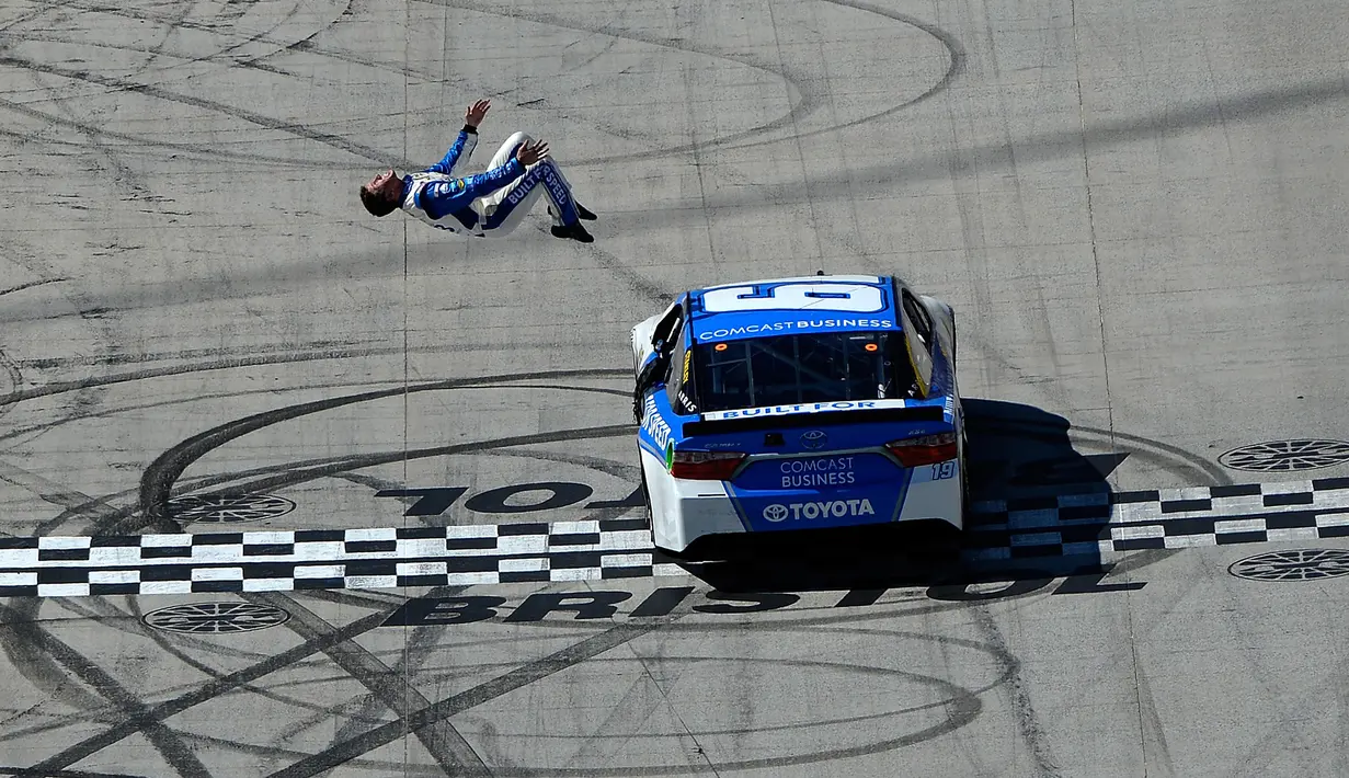 Aksi Carl Edwards salto saat merayakan kemenangan NASCAR Sprint Cup Series Food City 500 di Bristol Motor Speedway (17/4). Carl Edwards melakukan aksi berbahaya dengan salto dari mobil ketika mesin dalam keadaan berjalan perlahan. (AFP/Matt Sullivan)