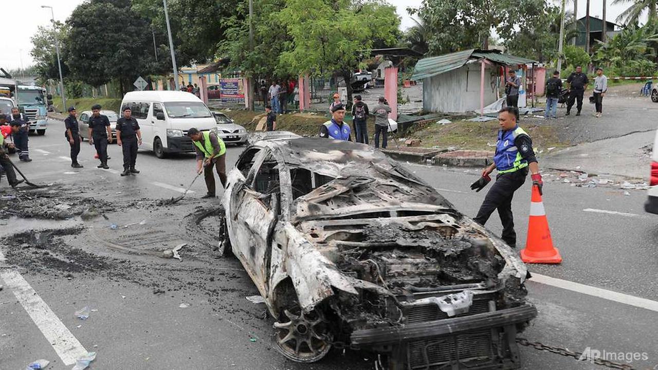 Mobil terbakar setelah kerusuhan pecah di dekat Kuil Sri Maha Mariamman di Petaling Jaya (AP/Vincent Thian)