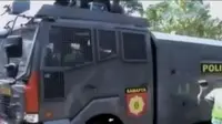 Kehadiran mobil water canon Polisi disamput warga Tasikmalaya dengan membawa ember dan baskom. 