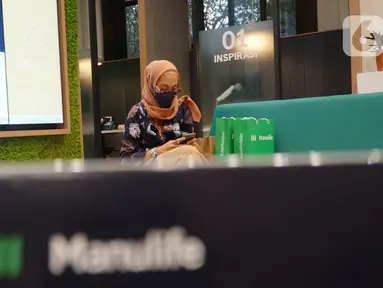 Karyawan beraktivitas dengan perangkat telpon di Gedung Manulife, Jakarta, Kamis (6/01/2022). Manulife dan IPB bekerjasama untuk penyaluran wakaf secara mandiri maupun donasi guna mendorong para milenial untuk berasuransi sejak dini melalui asuransi syariah. (Liputan6.com/HO/Eko)