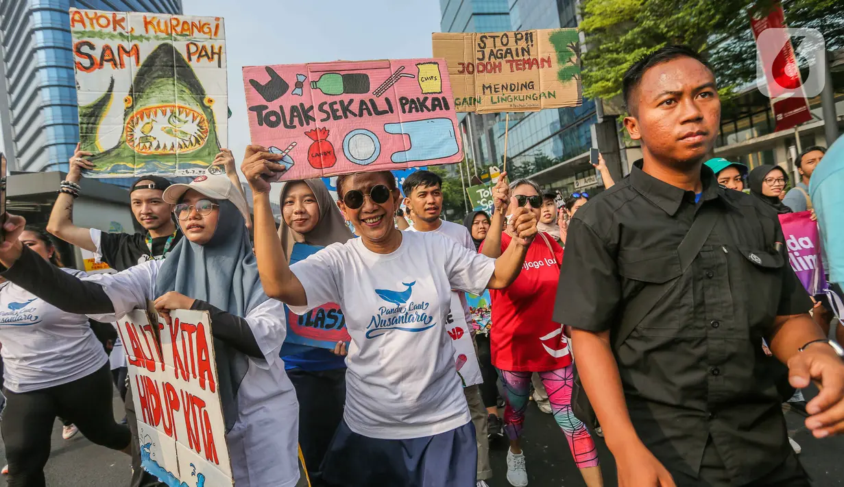 Di lokasi, Susi Pudjiastuti yang memakai kaus berwarna putih itu mengajak masyarakat memerangi pemakaian plastik sekali pakai. (Liputan6.com/Faizal Fanani)