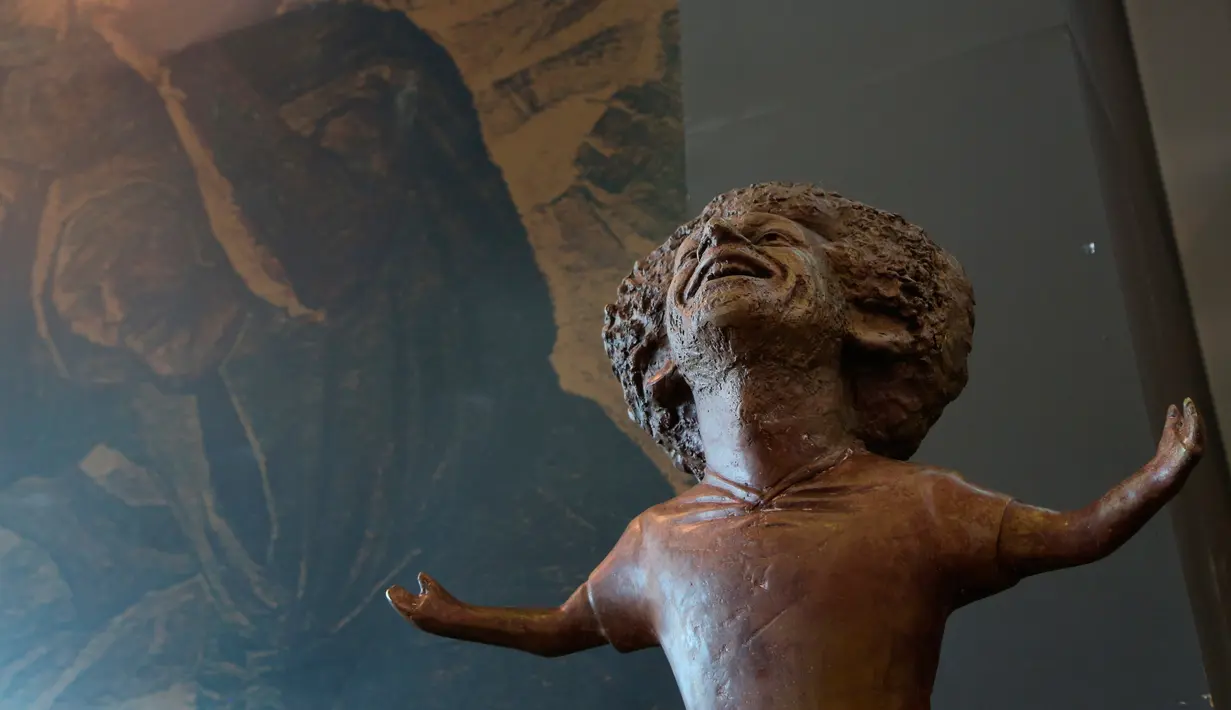 Patung perunggu bintang Liverpool, Mohamed Salah yang dipamerkan pada pertemuan World Youth Forum di Sharm al-Sheikh, Mesir, Senin (5/11). Patung karya Mia Abdel Allah ini menunjukkan pose membentangkan tangan khas selebrasi gol Salah. (AP/Ayman Aref)
