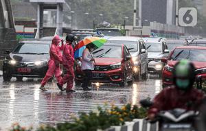 Pejalan kaki yang menggunakan payung saat hujan deras menyeberang jalan di kawasan Thamrin, Jakarta, Rabu (23/11/2022). Sejak Oktober, DKI Jakarta mulai memasuki musim penghujan yang sudah masuk ke dalam tahap ekstrem. (Liputan6.com/Faizal Fanani)